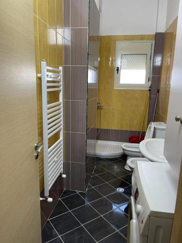 a bathroom with a shower and a sink and a toilet at BB City Hall in Vlorë