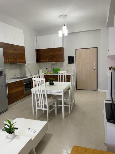 a kitchen and dining room with a table and chairs at BB City Hall in Vlorë