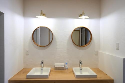 two sinks in a bathroom with two mirrors at 尾道stay源 -MINAMOTO- in Kaneyoshi
