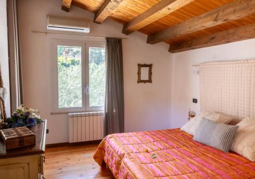 a bedroom with a bed and a large window at Villa Antico Pozzo piscina privata SPA in Castellammare del Golfo