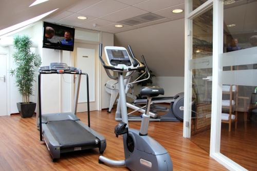 a gym with a treadmill and a exercise bike at Bastion Hotel Maastricht Centrum in Maastricht