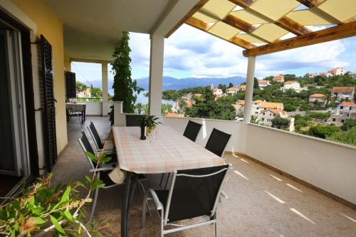 a table and chairs on a balcony with a view at Apartments Boro in Splitska