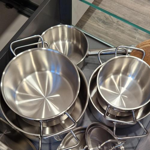 four metal pans sitting on top of a stove at Haus Ludwig in Freudenstadt