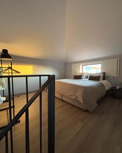 a bedroom with a bed and a window at Casa do Sorrio in Viana do Castelo