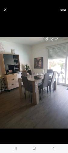 une cuisine et une salle à manger avec une table et des chaises dans l'établissement Maison rénovée proche circuit des 24H, au Mans