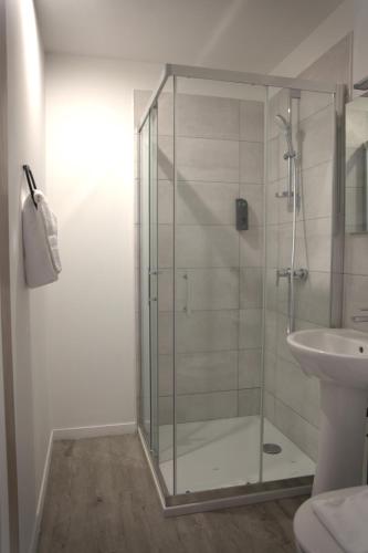 a bathroom with a glass shower and a sink at RELAIS 375 in Couhé-Verac