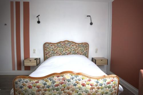 a bed with a floral headboard in a bedroom at RELAIS 375 in Couhé-Verac