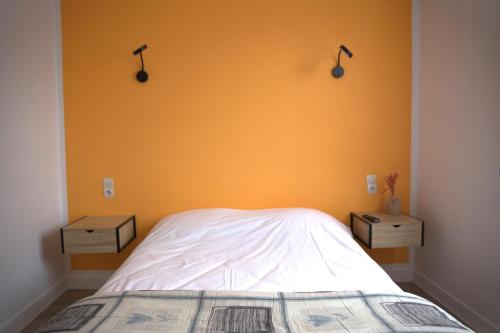 a bedroom with two night stands and a bed at RELAIS 375 in Couhé-Verac