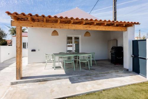 a pergola with a table and chairs on a patio at Country Pool House 27 in Abrantes