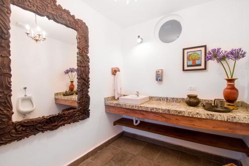 a bathroom with a sink and a mirror at Hacienda Rosas Pamba in Otavalo