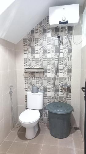 - une salle de bains pourvue de toilettes et d'une poubelle dans l'établissement MILLI Home - Family Home Stay, à Blimbing