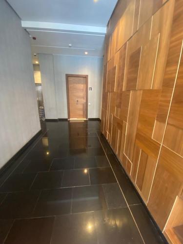 a hallway with wood paneled walls and a door at prestigieuse à casa finance city in Casablanca