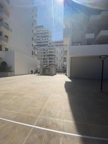 a large empty building with tall buildings in the background at prestigieuse à casa finance city in Casablanca