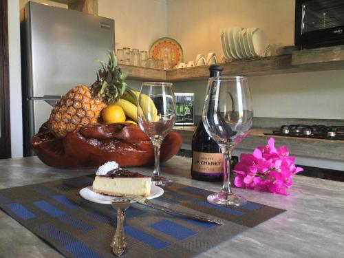 a table with a plate of fruit and wine glasses at Mar y Montaña in Copecito