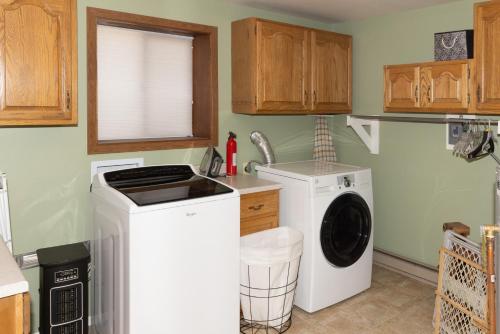 a kitchen with a washing machine and a sink at Lazy Bear Lodge in Florissant with Mountain Views! in Florissant