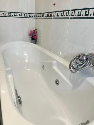 a white bath tub with a faucet in a bathroom at Nuovo appartamento "Lux" in San Benedetto del Tronto