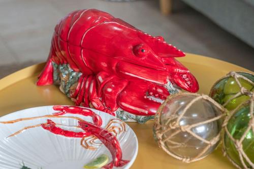 a red bird statue sitting on a yellow plate at The Lighthouse at Iluka Resort Apatments in Palm Beach