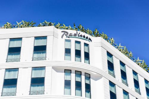 a white building with a radisson hotel sign on it at Radisson Hotel Casablanca Gauthier La Citadelle in Casablanca