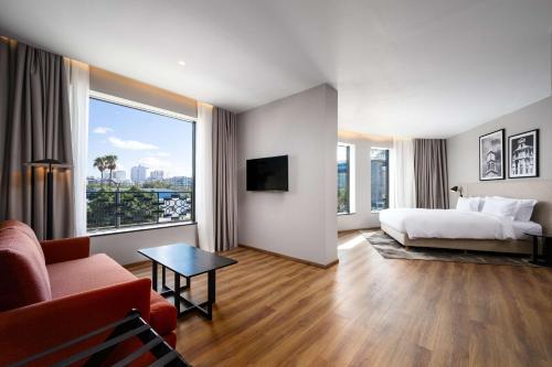 a hotel room with a bed and a large window at Radisson Hotel Casablanca Gauthier La Citadelle in Casablanca