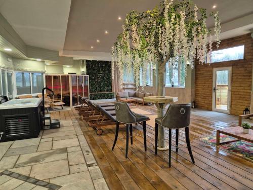 a living room with a table and chairs and a tree at Hall Garth Hotel; BW Signature Collection in Darlington