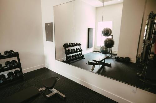 a mirror in a room with a chair and weights at Chic Cozy Retreat - 2BR - Stunning North End Views in Halifax