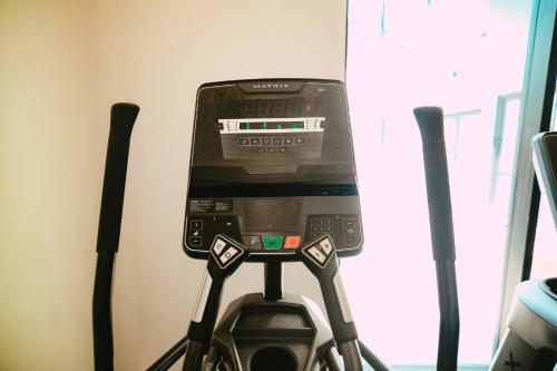 a cell phone on top of a gym machine at Chic Cozy Retreat - 2BR - Stunning North End Views in Halifax