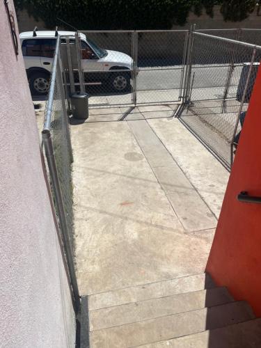 a chain link fence next to a concrete sidewalk at Casa de chapis in Ensenada
