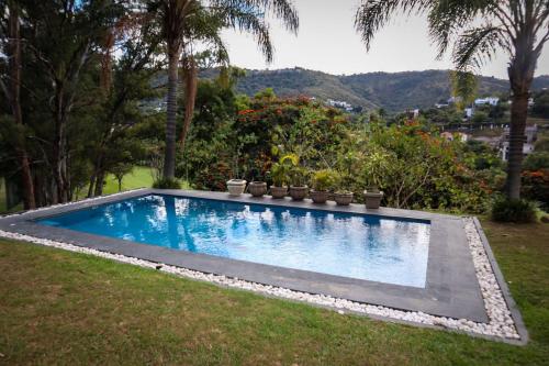 a swimming pool in the middle of a yard at Casa de campo en Las Cañadas Zapopan Jal. in Guadalajara