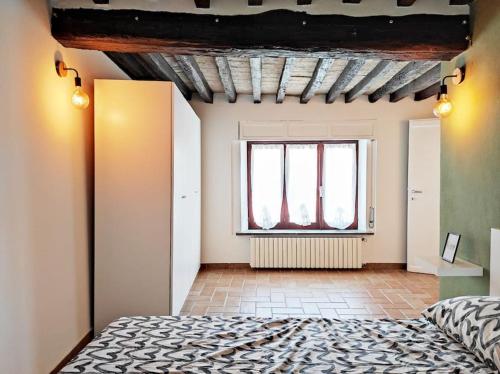 a bedroom with a bed and a window at S7Home in Parma
