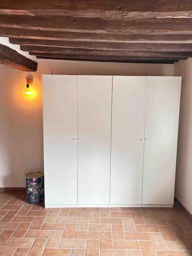 a white cabinet in the corner of a room at S7Home in Parma