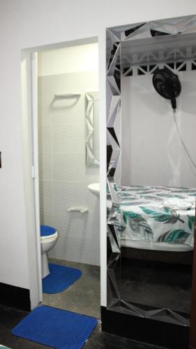 a bedroom with a bunk bed and a toilet at Hostal Queens Deluxe in Florencia