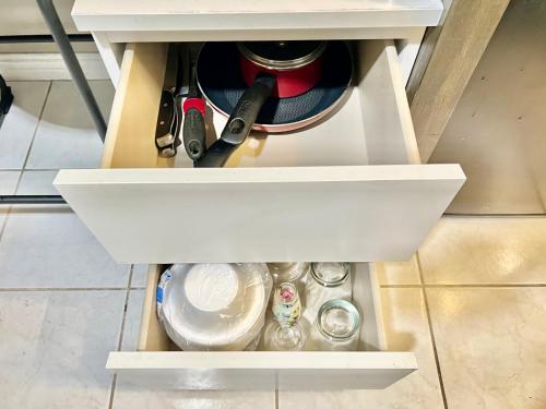 a drawer in a cabinet filled with utensils at Modern 1 Bedroom Home W/ Sauna & Shower-Jets in Carson