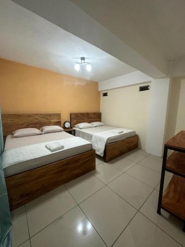 a bedroom with two beds in a room at Grupo Small Ville in Guatemala