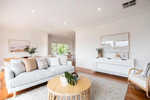 a living room with a white couch and a table at Casa Estiva in Rye