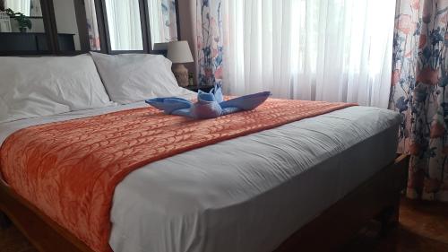 a bedroom with a bed with a laptop on it at El Encanto Condominiums in Jacó