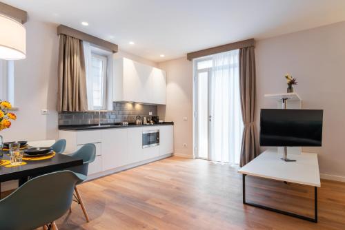 a kitchen and living room with a television on a table at Major House - Luxury Apartments in Rome