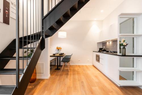 a kitchen and dining area with a staircase in a loft at Major House - Luxury Apartments in Rome by Hostand in Rome