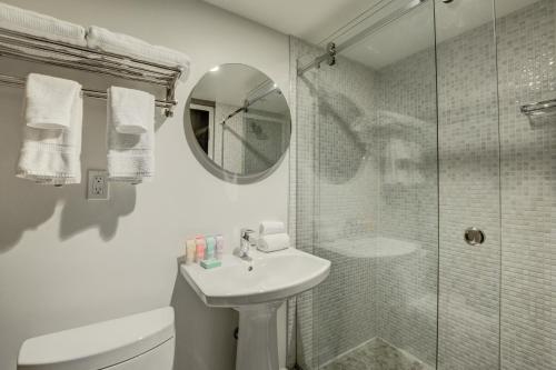 a white bathroom with a sink and a shower at Oasis at Gold Spike in Las Vegas