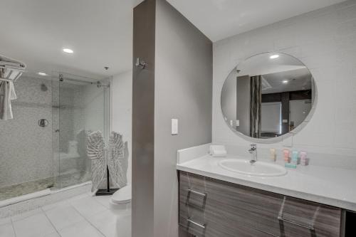 a bathroom with a sink and a mirror at Oasis at Gold Spike - Adults Only in Las Vegas