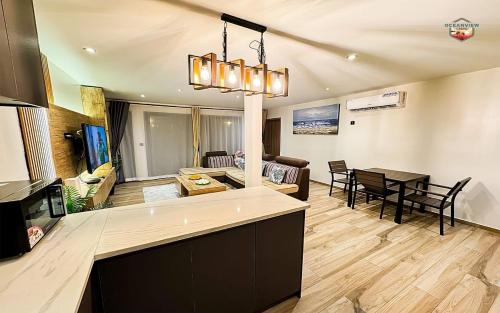 uma cozinha e sala de estar com uma mesa e um sofá em Newly Built Luxury Beachfront Villa em Acra