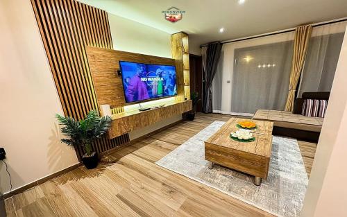 uma sala de estar com uma televisão e uma mesa de centro em Newly Built Luxury Beachfront Villa em Acra
