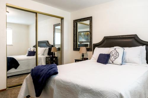 a bedroom with a large bed and two mirrors at Quiet Kennewick Condos in Kennewick