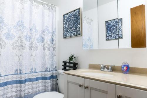 a bathroom with a sink and a toilet and a mirror at Quiet Kennewick Condos in Kennewick
