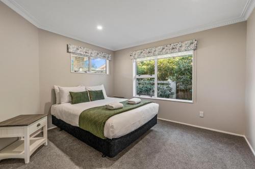 A bed or beds in a room at Good as Gold - Taupo