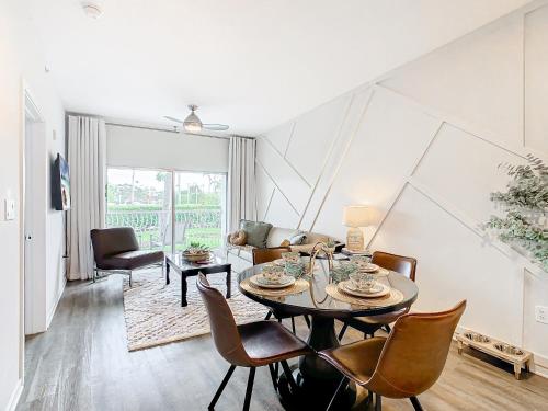 a living room with a table and chairs at 1Bed/1Bath Pet Friendly Condo at the Melia in Orlando