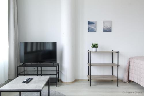 a living room with a tv and a coffee table at City Apartment Pankkitalo in Kuopio