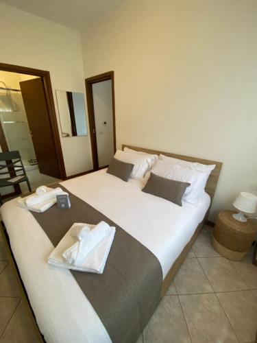a bedroom with a large bed with towels on it at Casa Oasi in Seriate