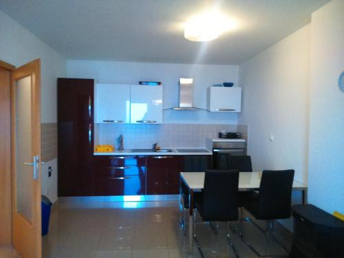 a kitchen with a table and chairs in a room at Apartment Hajdo in Rijeka