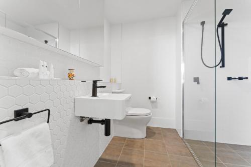 a bathroom with a toilet and a sink and a shower at Bright 1-Bed by Natural Reserves with Pool & Gym in Harrison