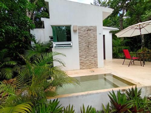 a villa with a pool in a garden at Villa Ixchel private pool in Tulum